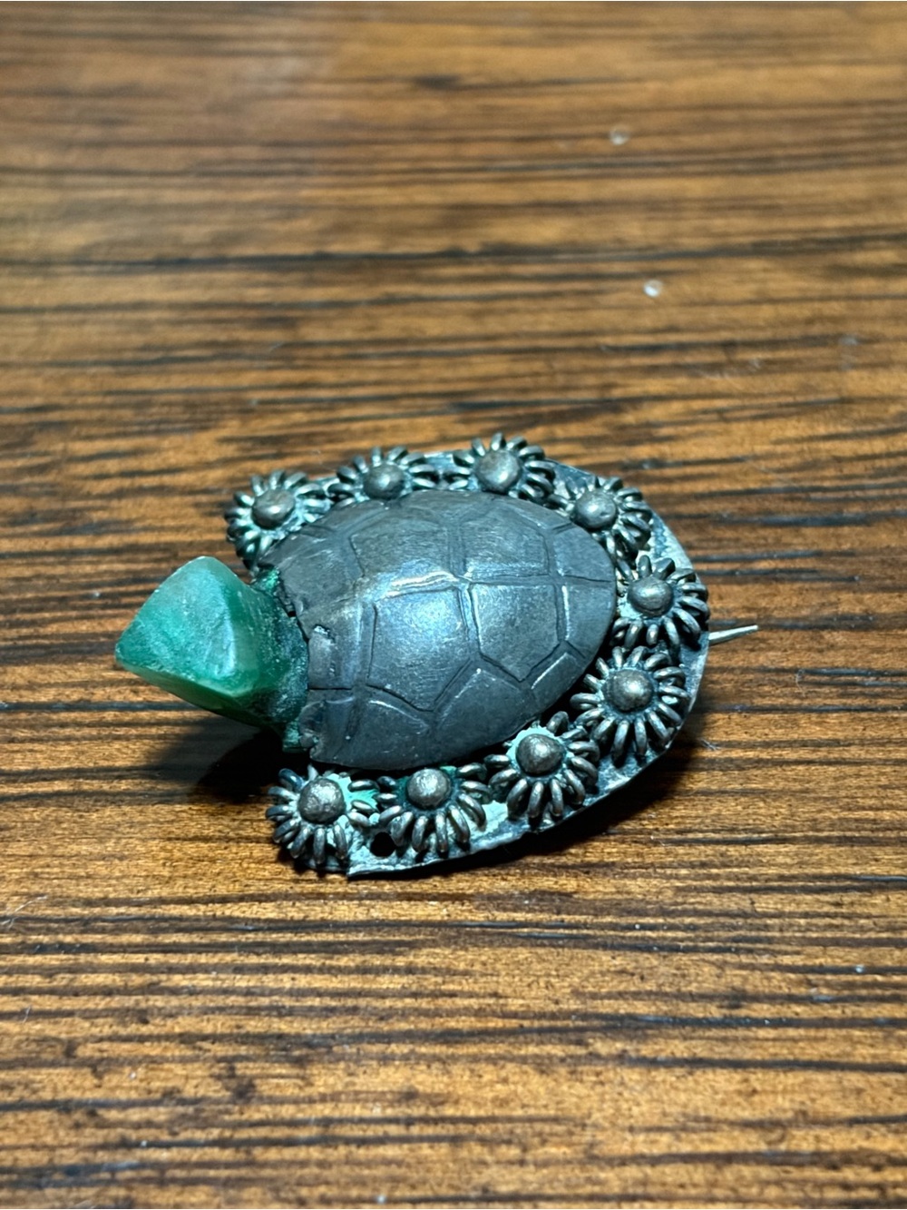 vintage-style brooch likely features a sterling silver turtle shell with a green